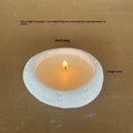 Fair-faced concrete candlestick ornament in white colour on a flat surface