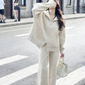Knitted zipper cardigan and wide-leg trousers two-piece set in solid colour on a mannequin.
