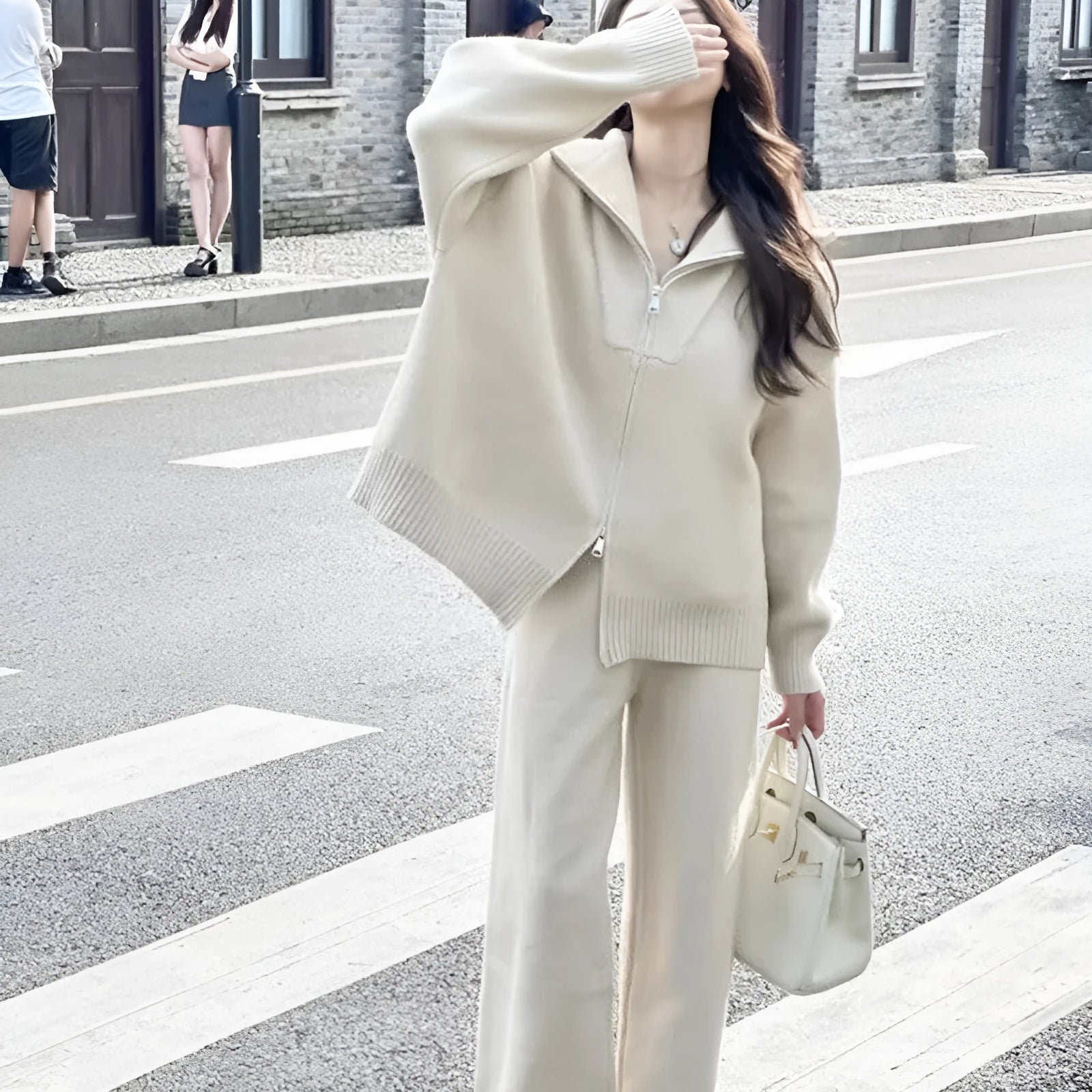 Knitted zipper cardigan and wide-leg trousers two-piece set in solid colour on a mannequin.