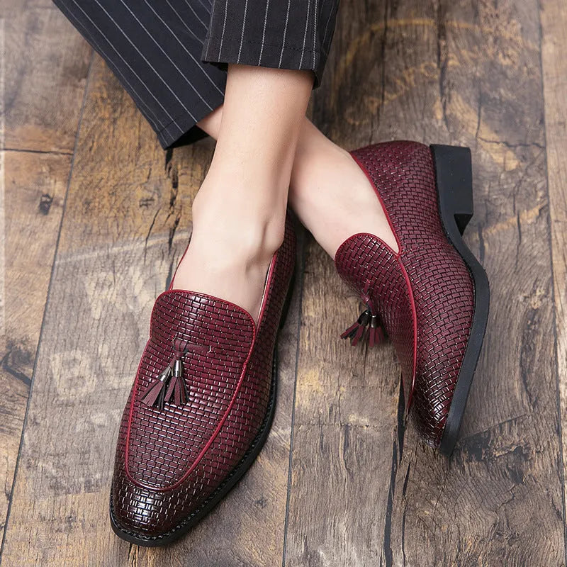 Men's black pointed slip-on shoes with a tassel detail on the front, made from artificial PU.