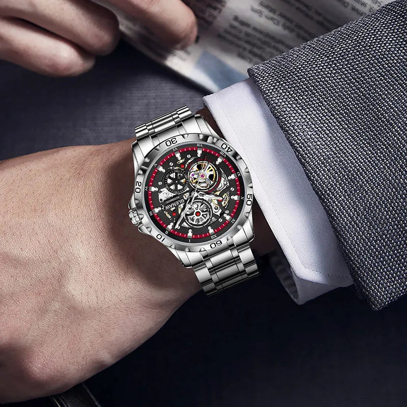 Silver men's automatic watch with hollow-out dial, luminous hands, and stainless steel strap.