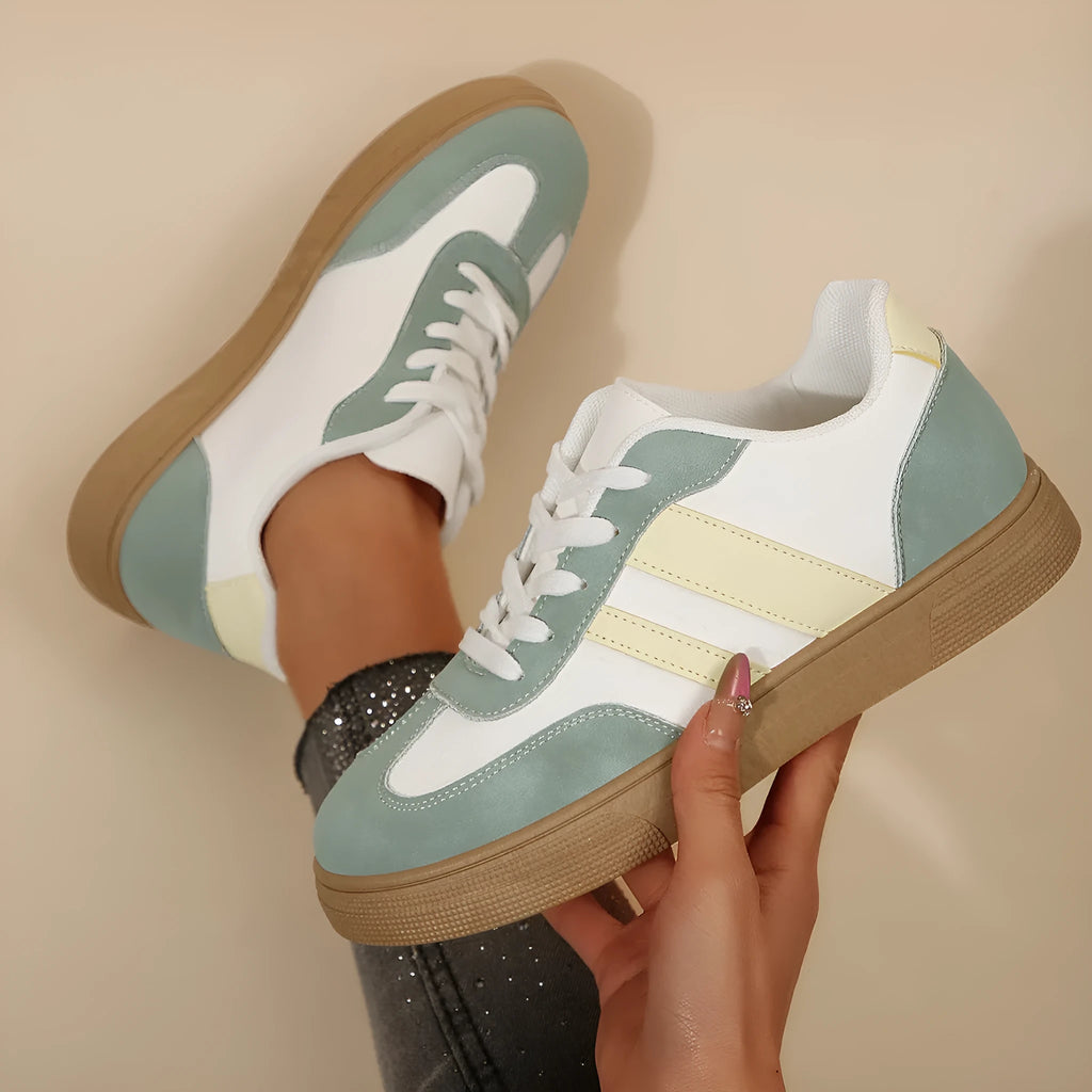 Women's green retro sports shoes with white cross straps, low top, flat rubber sole, and round toe.