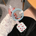 Set of lambskin USB cable protection sleeves in checkered puppy and polka dot puppy designs.