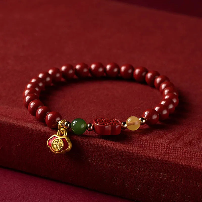 Happy Eyebrow bracelet made of raw Emperor Sandstone beads with a red Cinnabar and fu character charm.