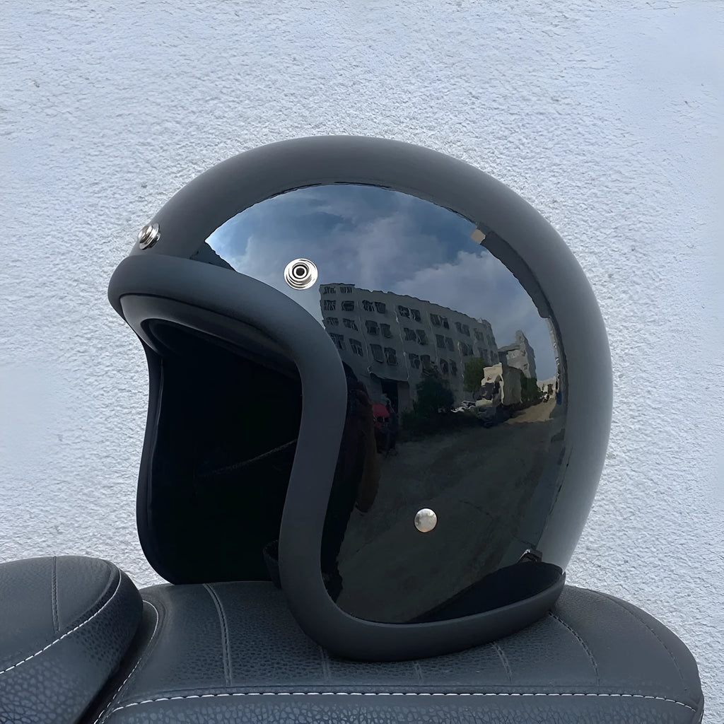 Cement grey retro half motorcycle helmet with glass fibre shell on a plain background.