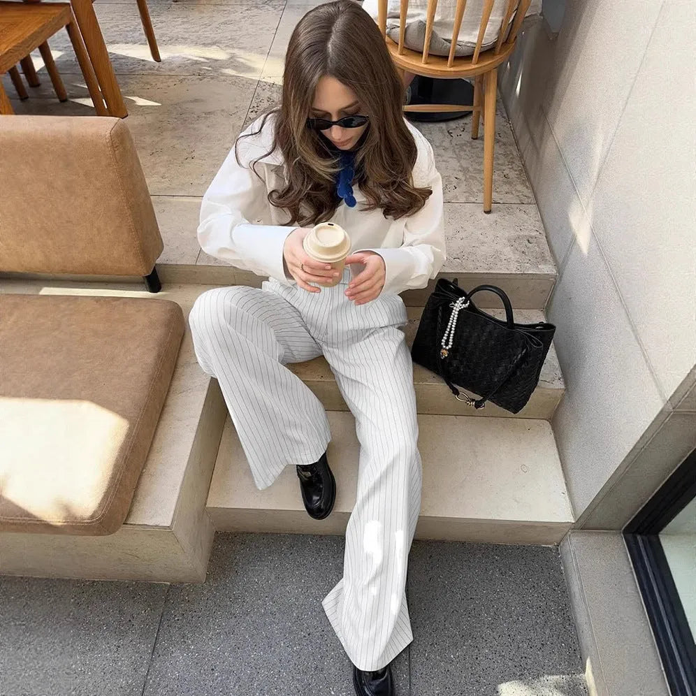 Women's white striped wide-leg trousers with side zip on mannequin