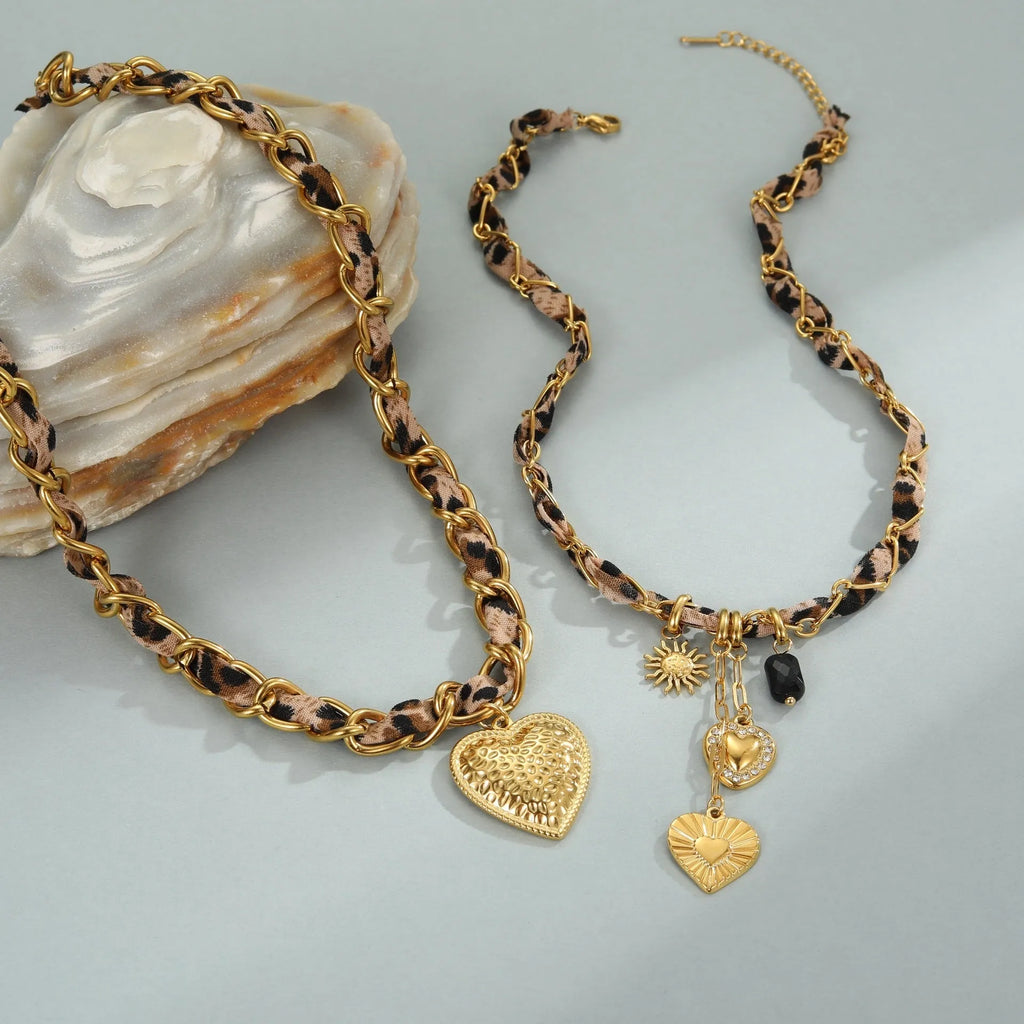 Gold plated leopard print stainless steel necklace with big heart or love sun pendant on a chain.