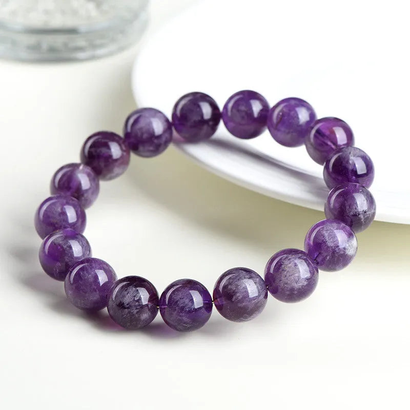 Natural purple Snow Mountain feather amethyst crystal bracelet with scattered geometry beads and Ruyi element.