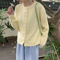 Women's cashmere blend cardigan sweater with pearl buttons and bow detail in solid colour