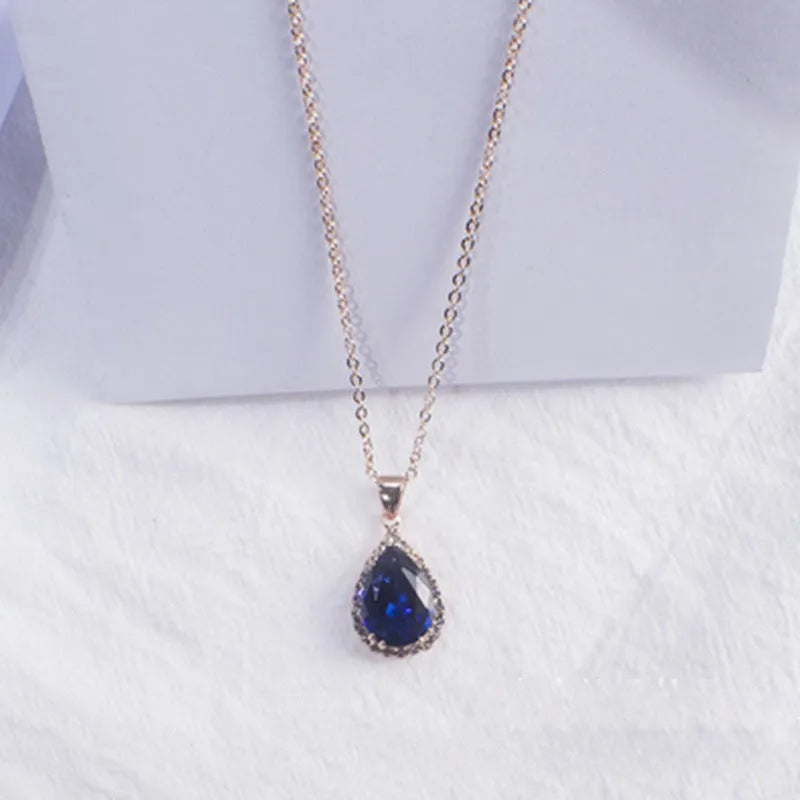 Women's geometric drop shape pendant necklace with rhinestone detail in pink electroplated finish.