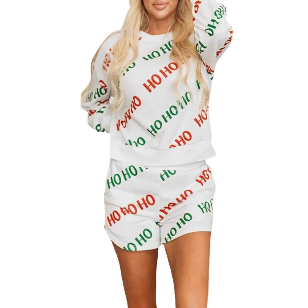 White women's two-piece suit with black letter print, long sleeves, and matching cropped pants.