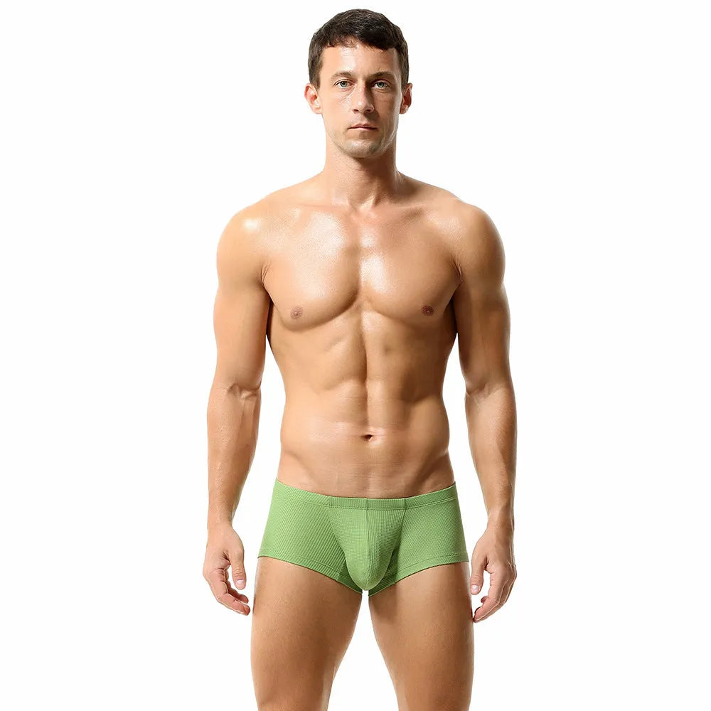 Men's solid colour low waist nylon boxer shorts laid flat, showing orange, blue, green, light blue, and white colour options.