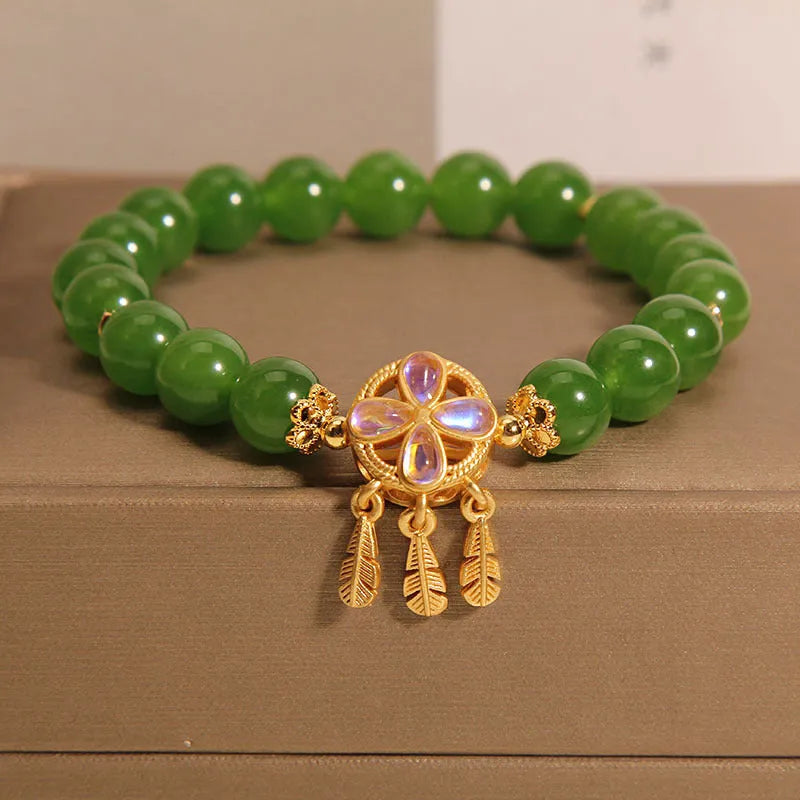 Green Jasper Crystal four-leaf clover dreamcatcher pendant on a women's bracelet.