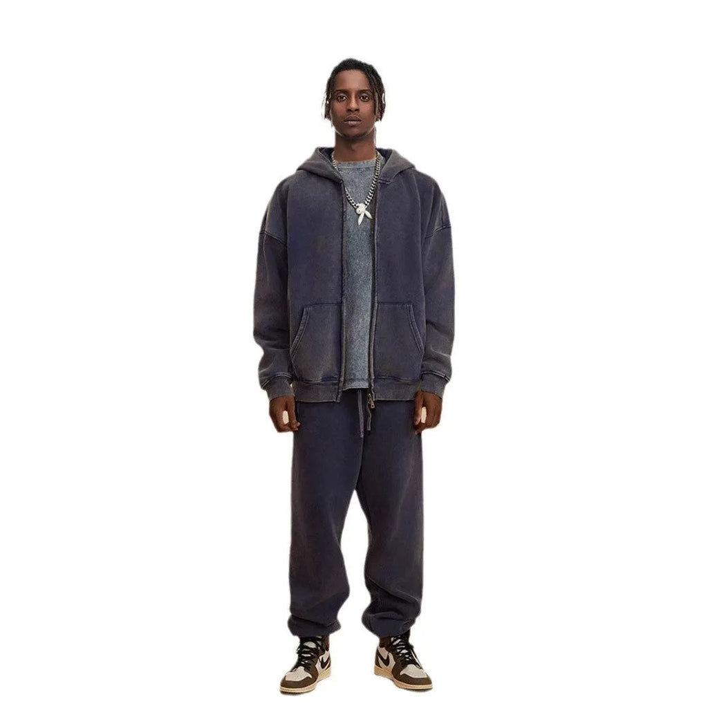 Man wearing a vintage wash fleece-lined hooded cardigan with a double zipper, shown in dark green.
