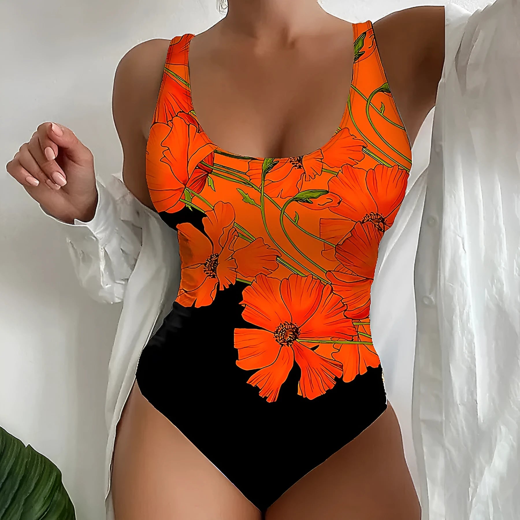 Women's orange floral print backless one-piece swimsuit on a model