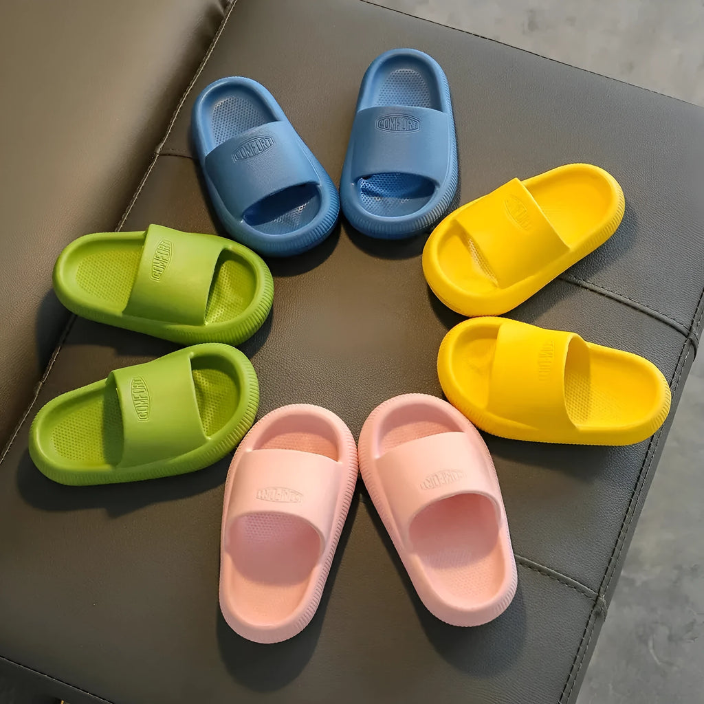 Children's colourful EVA slippers showing non-slip sole, available in blue, green, orange, pink, and yellow.
