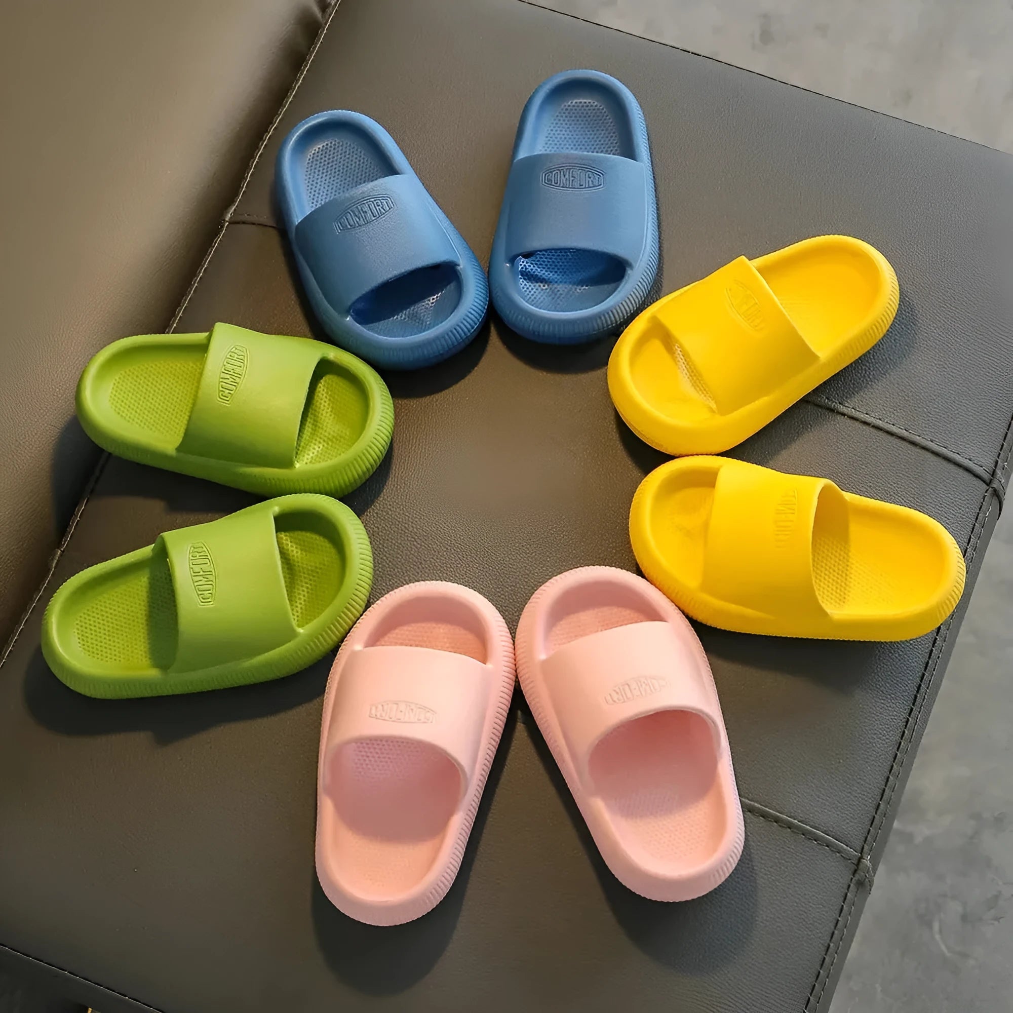 Children's colourful EVA slippers showing non-slip sole, available in blue, green, orange, pink, and yellow.