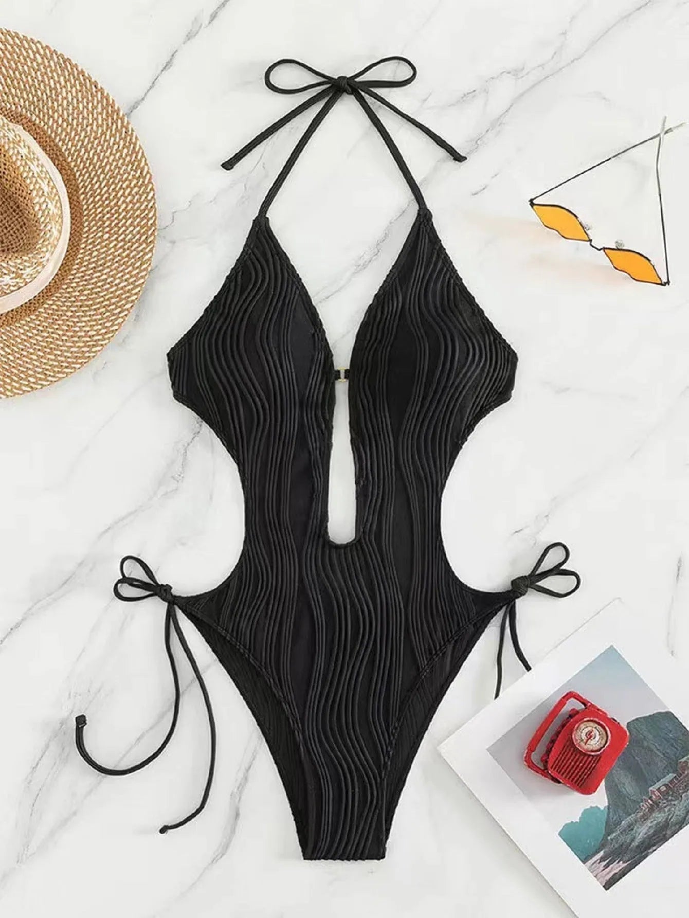 Black and white lace-up triangle bikini swimsuit for women on a size chart background