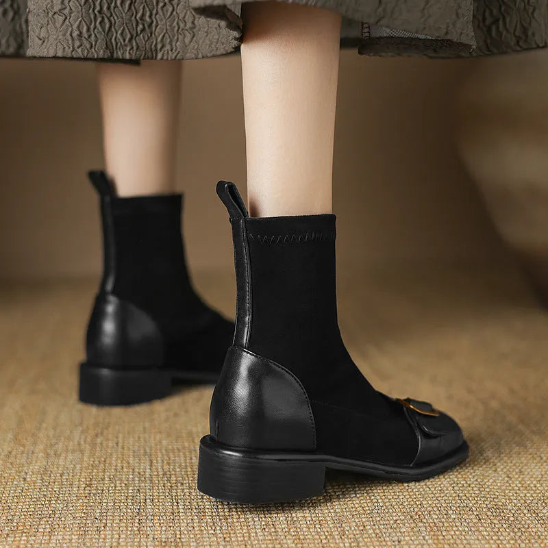 Women's black low heel Martin boot with front lace-up and silver ankle buckle on a round toe.