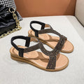 Gold women's patent leather sandals with rhinestone decoration on the strap and a non-slip sole.