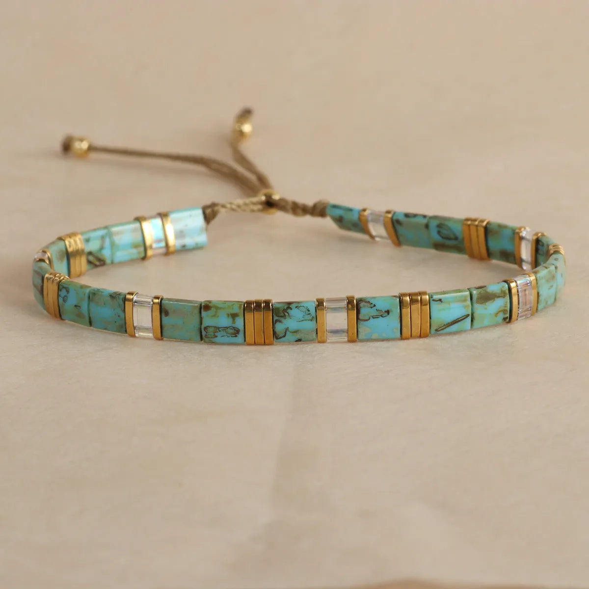 Adjustable glass beaded bracelet in geometric design with round beads available in five colours