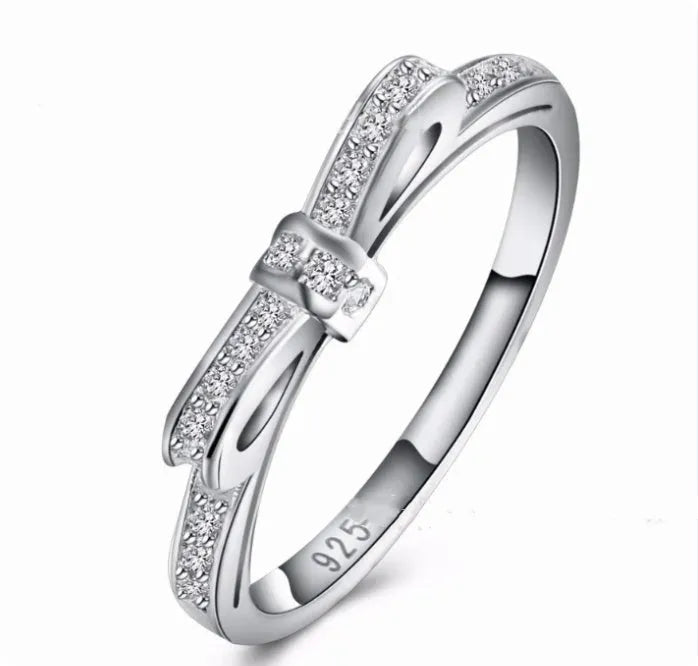 Silver couple's ring with bow design and zircon crystal rhinestones on sterling silver band