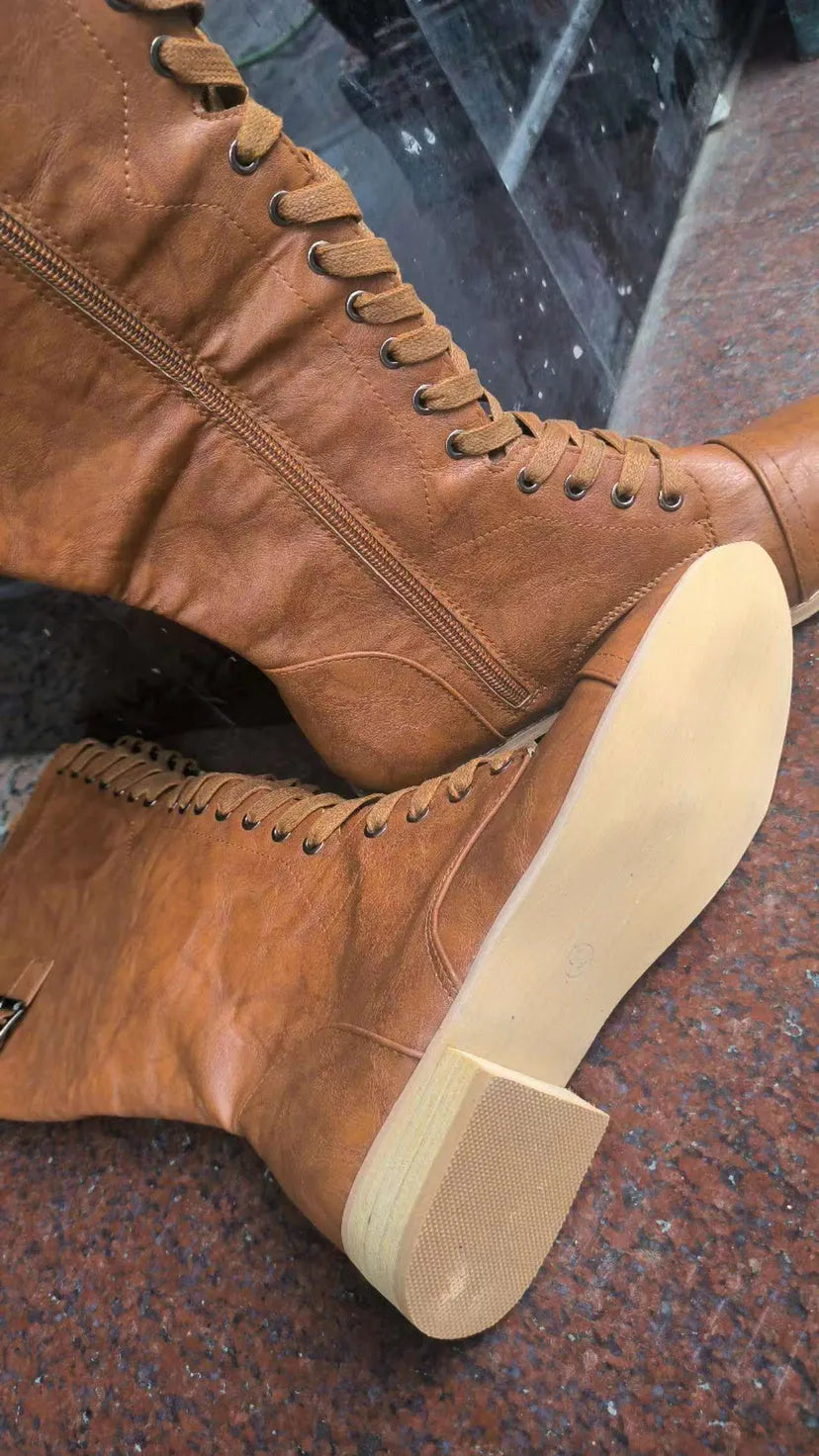 Women's black artificial PU knight boots with cross strap detail on ankle.
