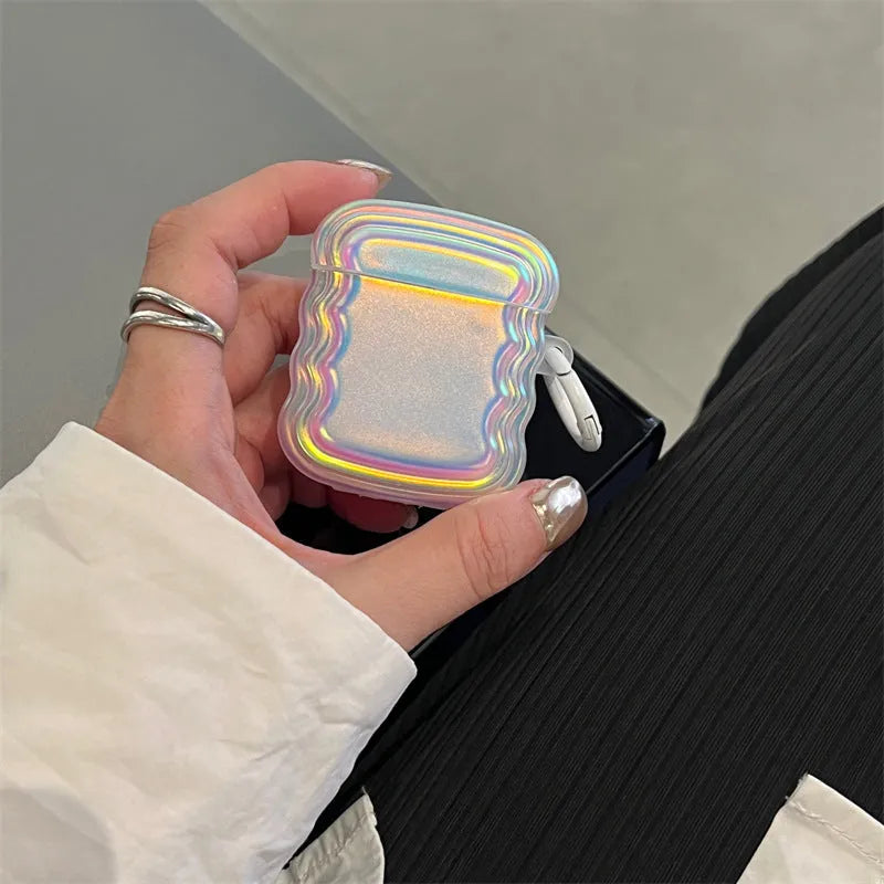 Silicone AirPods case with holographic laser ring design, shown next to AirPods Pro 2 and AirPods 3.