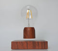 Glass and ABS magnetic levitation bulb floating above an imitation wood base.