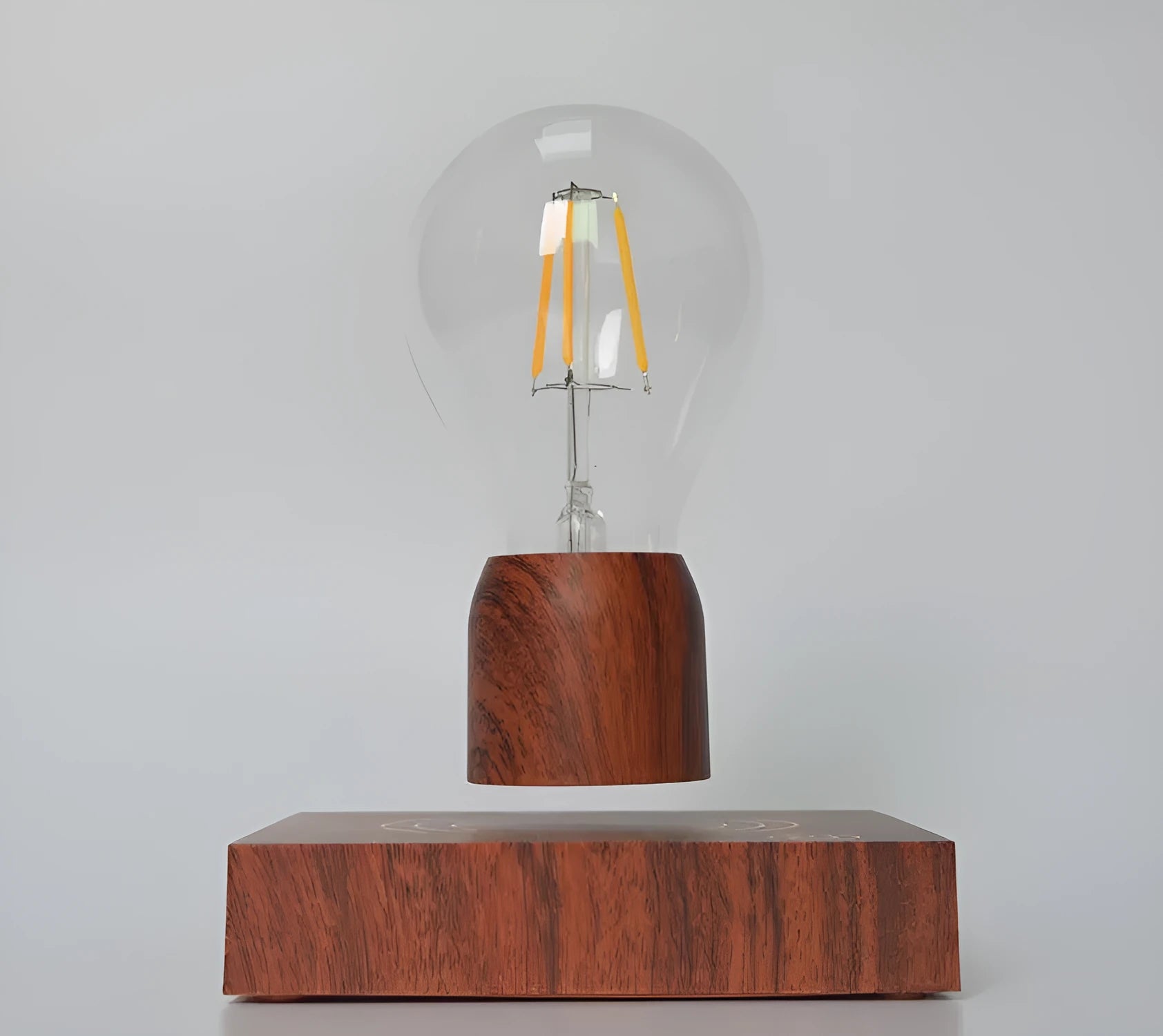 Glass and ABS magnetic levitation bulb floating above an imitation wood base.