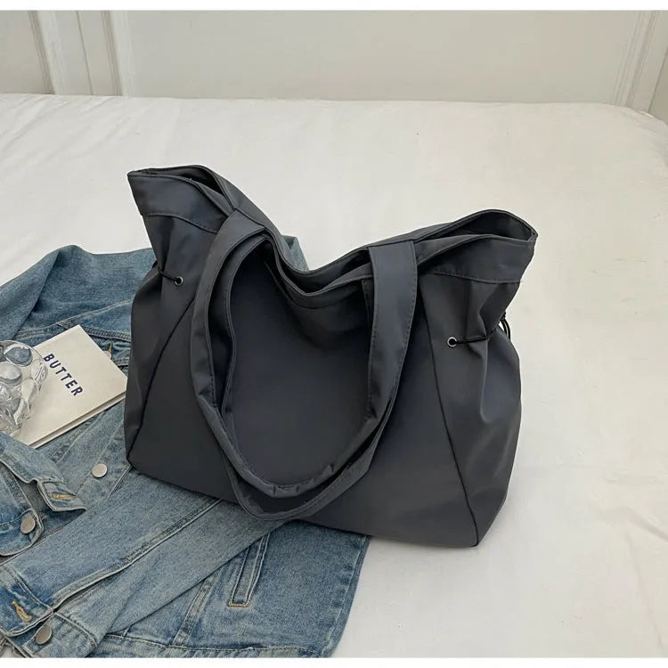 Oxford cloth folding shoulder tote bag in a choice of five colours including black, brown, and purple.