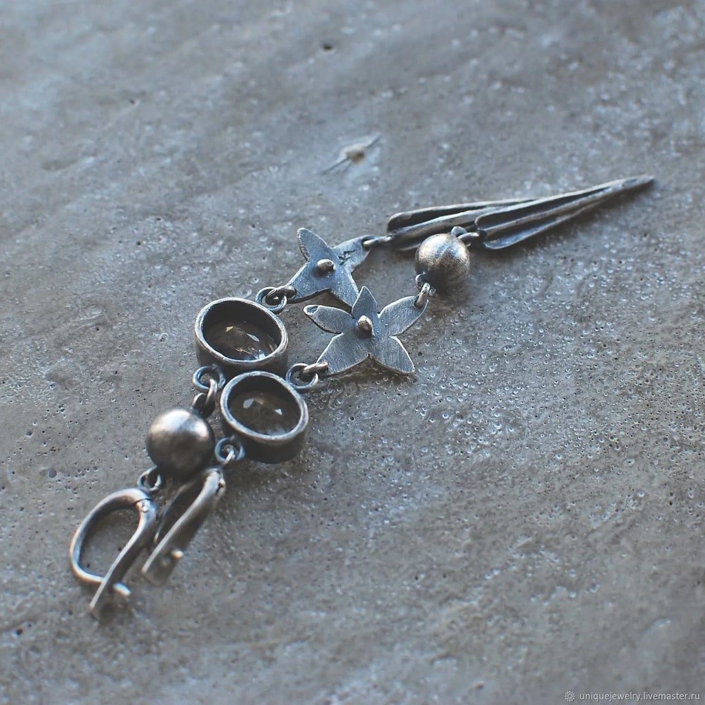Geometric XINGX pendant earrings with antique silver finish and rhinestone detailing