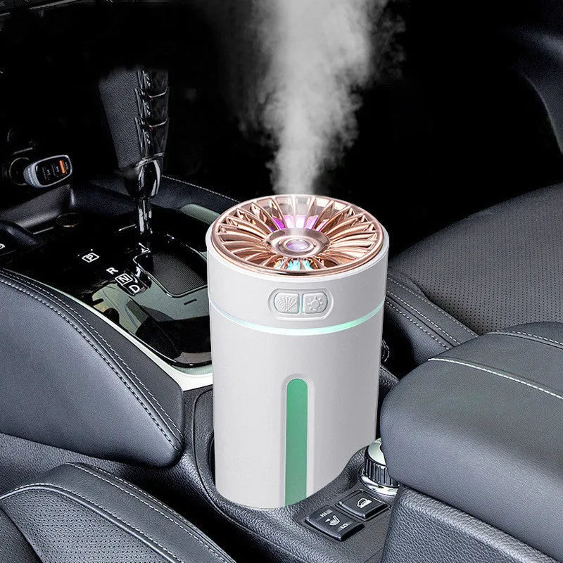 Black portable car humidifier with colourful LED lights showing mist output, placed in vehicle cup holder