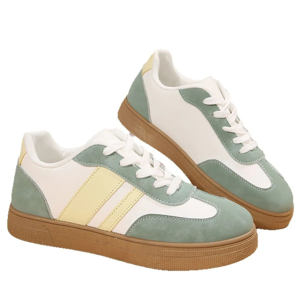 Women's green retro sports shoes with white cross straps, low top, flat rubber sole, and round toe.