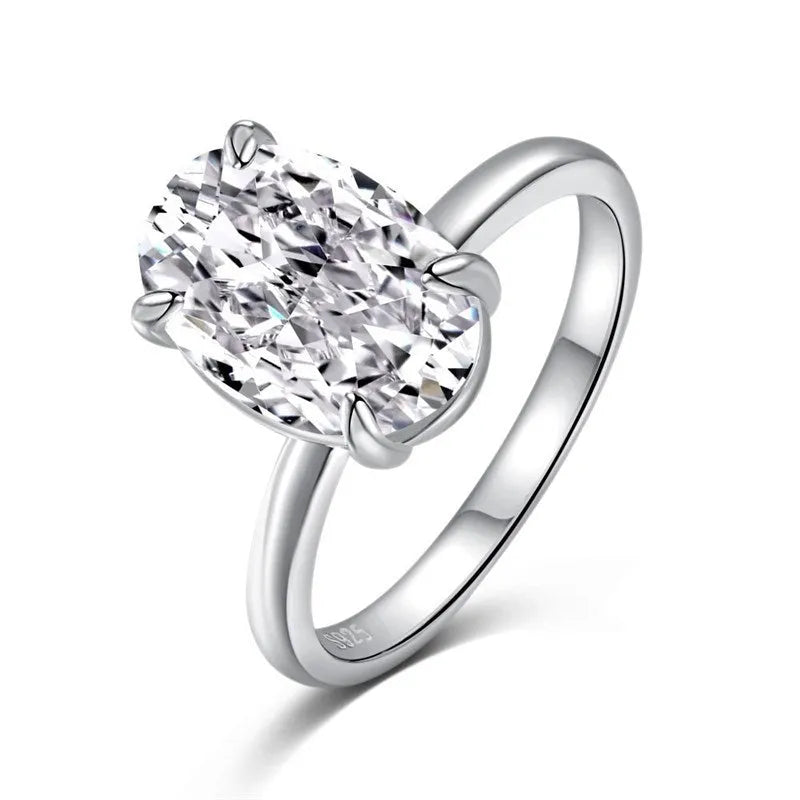 Oval women's ring in silver with four-claw setting holding a hand-cut gem.