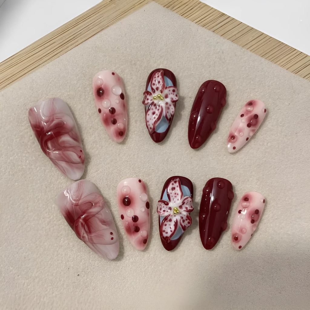 Hand-painted three-dimensional carved artificial nails in almond shape with floral and geometric patterns