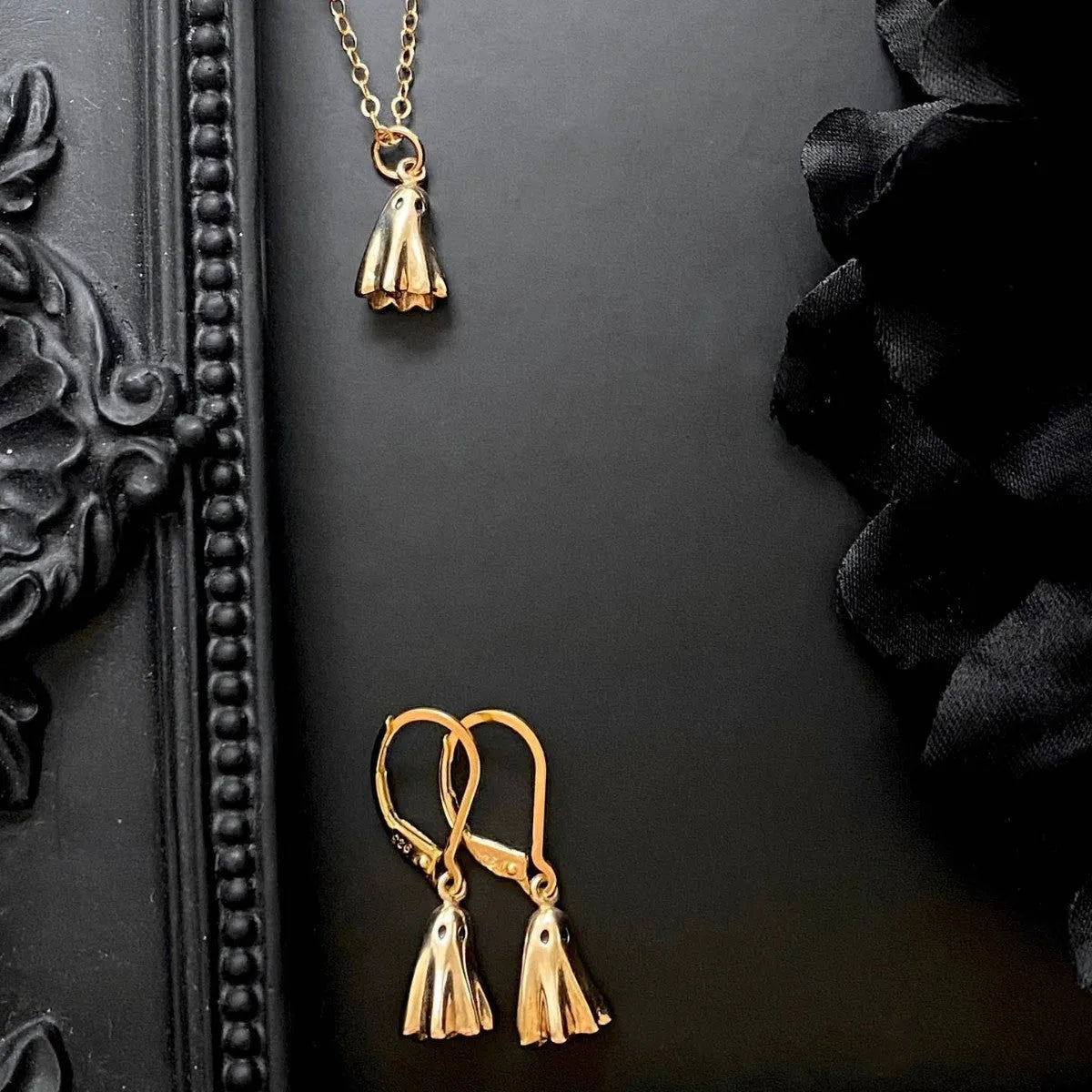 Ghost pendant necklace with twisted stainless steel chain, shown in available chain style options.