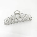 Women's minimalist hair clip in gold or silver with geometric tassel decoration