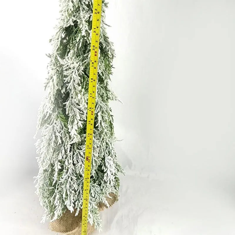 Small 24-inch artificial Christmas tree with snow-spray branches and built-in lights for desktop decoration