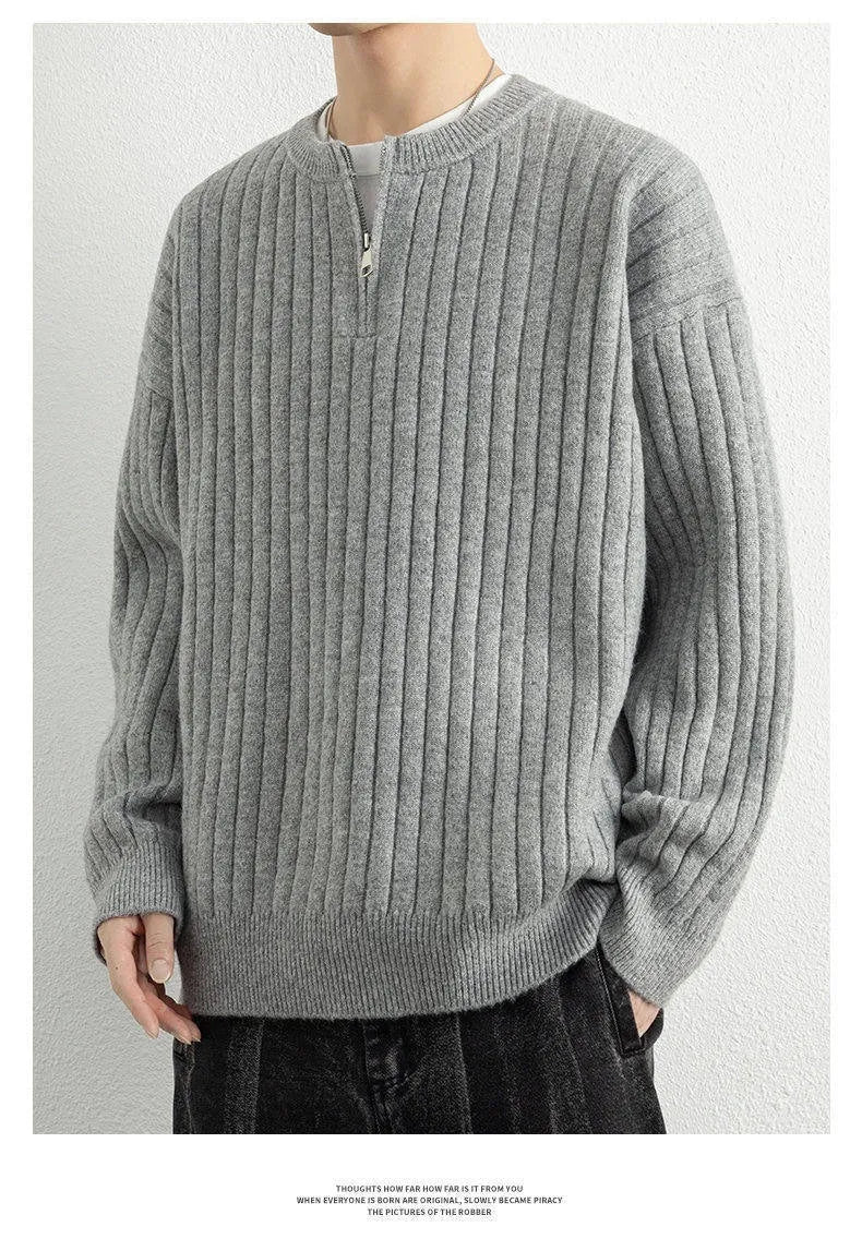 Man wearing a grey half-zip textured knit pullover sweater with a loose fit.