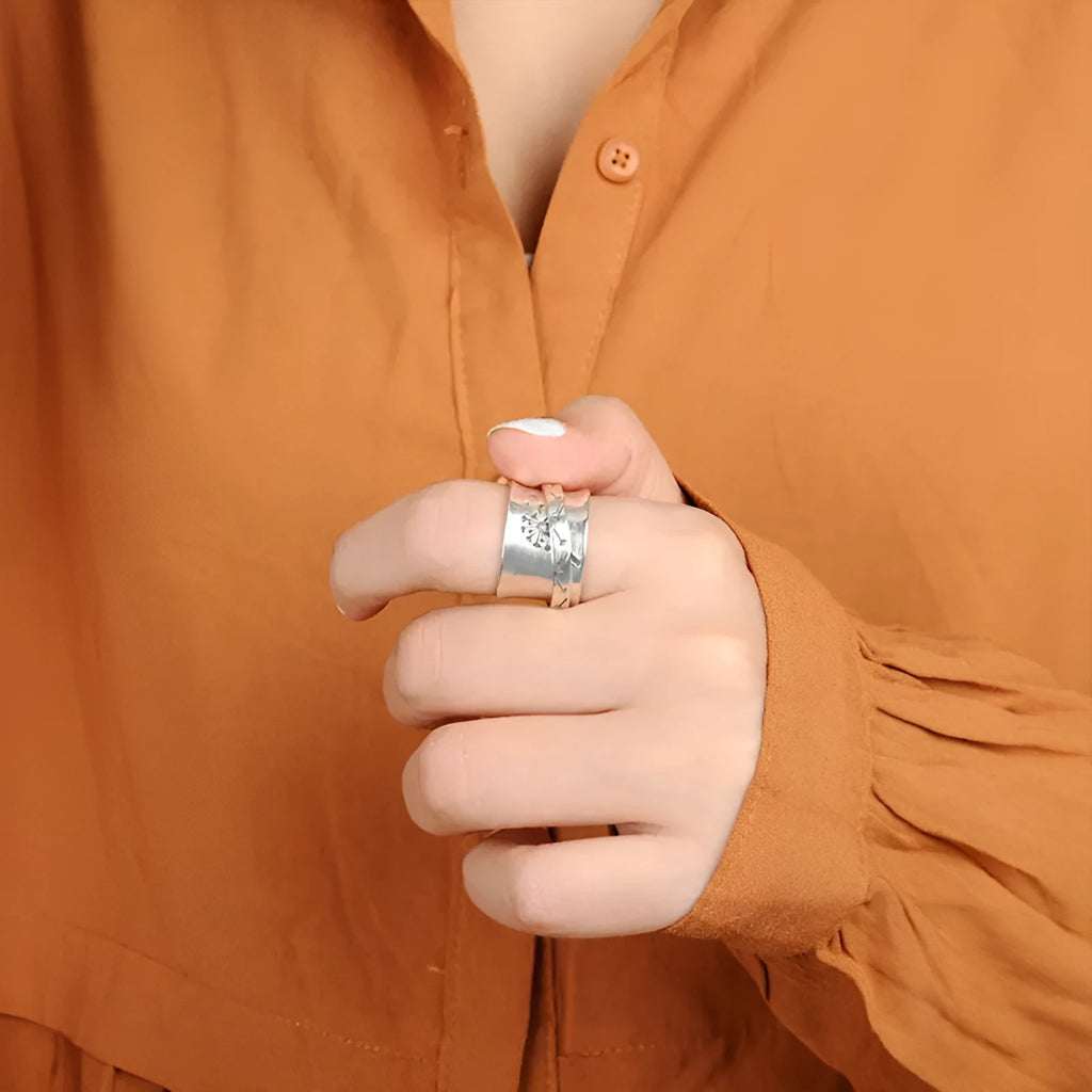 Adjustable silver flower ring with rotatable design fits five finger sizes