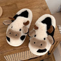 White cow-themed plush slippers for women with a non-slip textured sole.