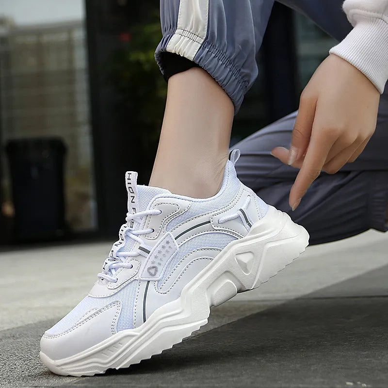 Women's white casual sports shoes with mesh upper, thick PU sole, buckle detail, and round toe.