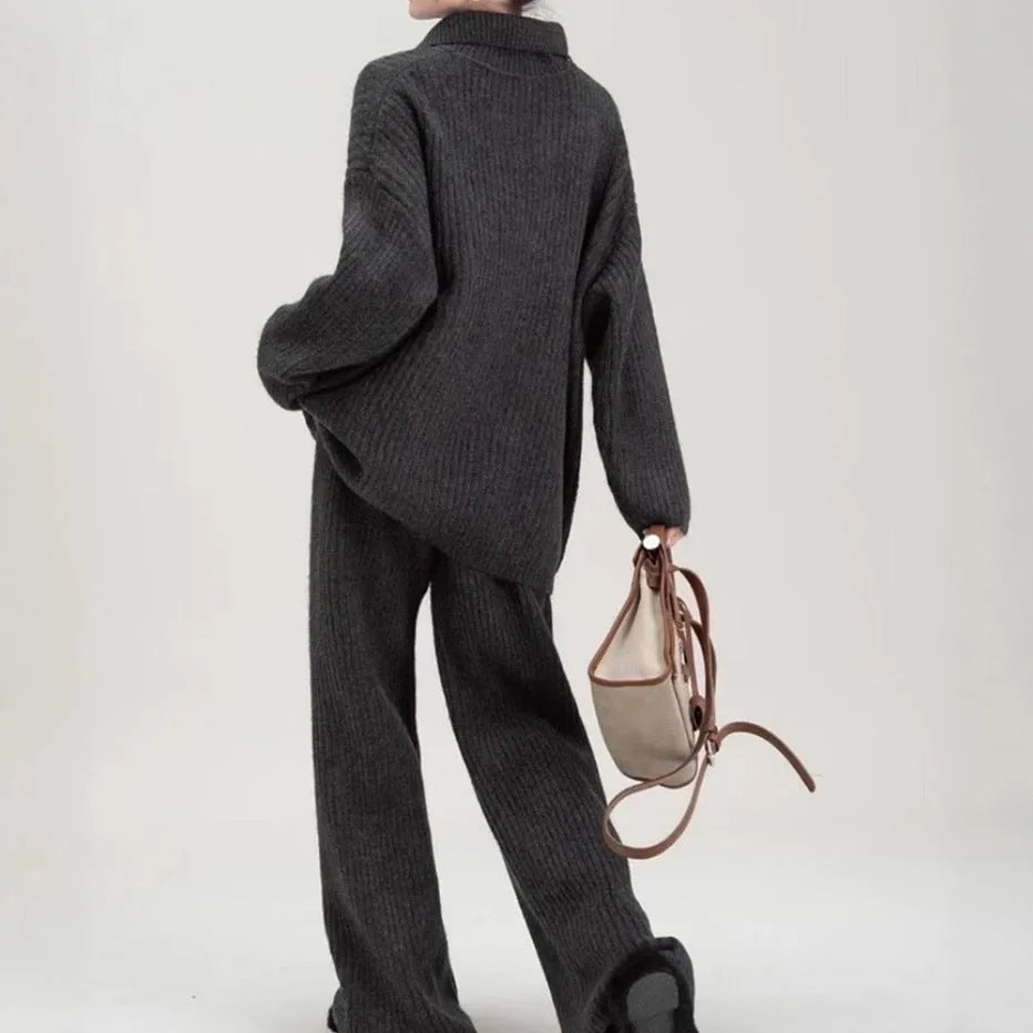 Women's dark grey knit top and trousers two-piece sweater suit set on a hanger