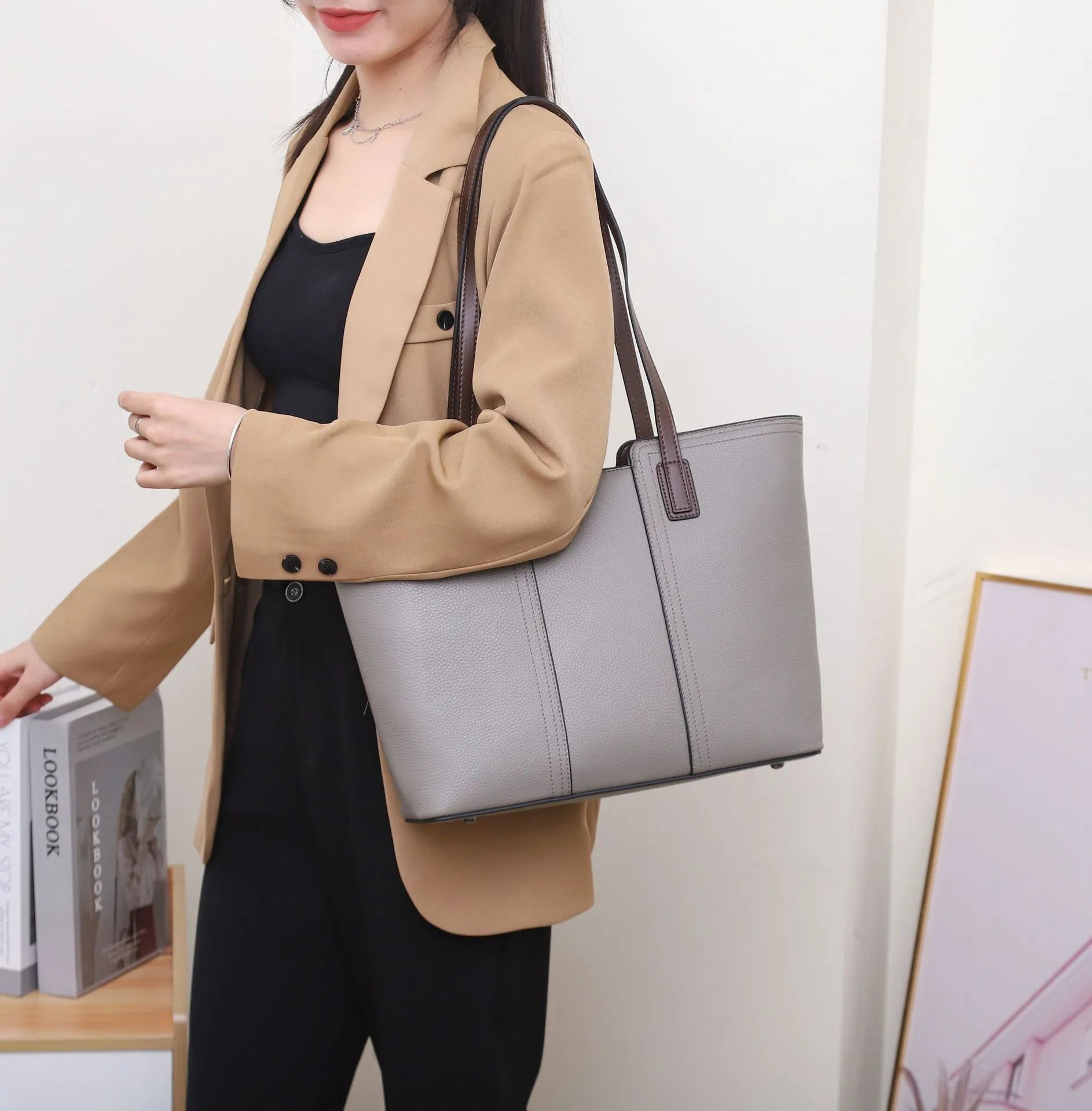 Genuine leather box-type shoulder bag in khaki colour with a sewing line detail and sandwich pocket.