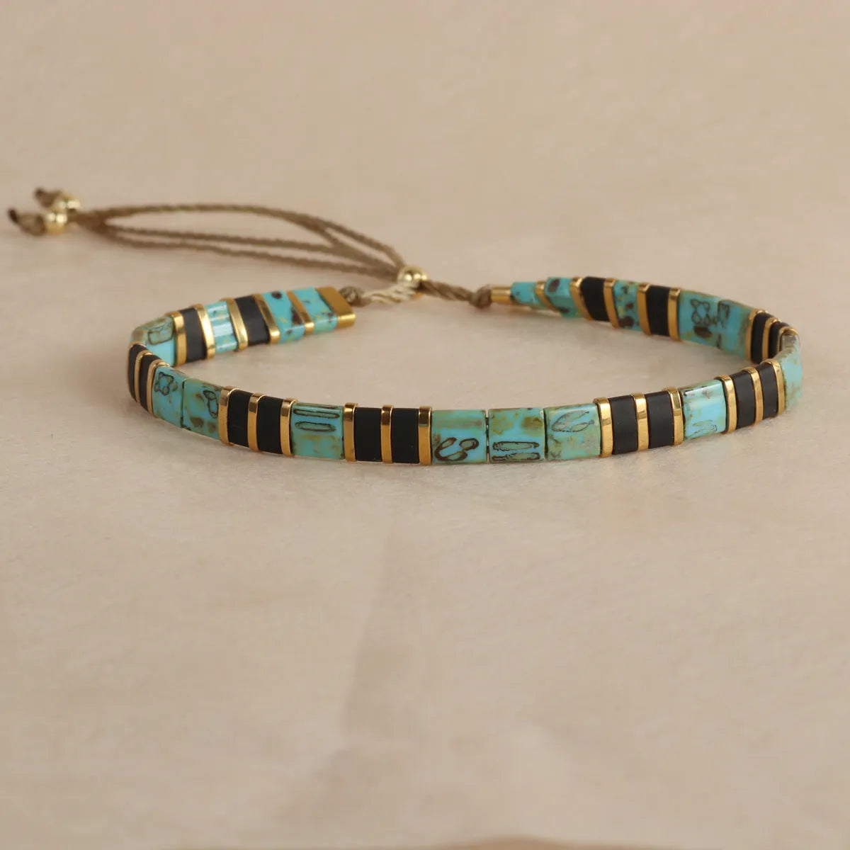 Adjustable glass beaded bracelet in geometric design with round beads available in five colours