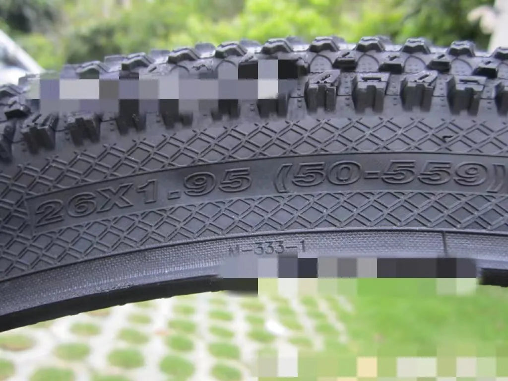 Ultralight mountain bike tyre with knobbly tread, shown in multiple size options including 26, 27.5 and 29 inch.