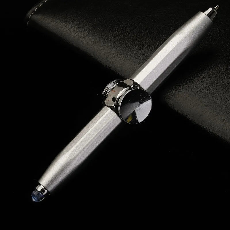 Metal LED spinning gyro ballpoint pen in hand, showing fidget spinner top and pen tip.