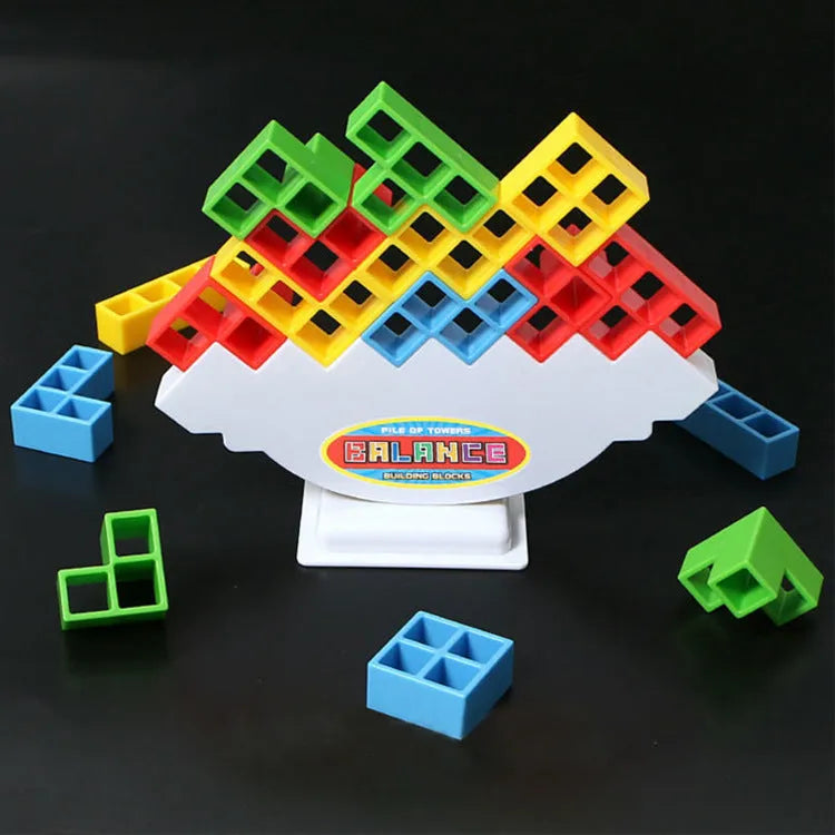 Plastic balance stacking board game with 16 colourful building blocks, a chassis, and a base on a flat surface.