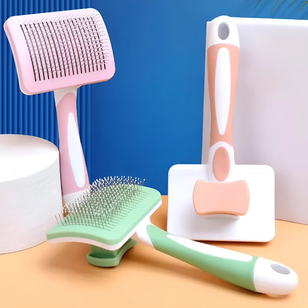 Self-cleaning slicker brush for dogs and cats with one-click hair removal button, available in green, orange, and pink